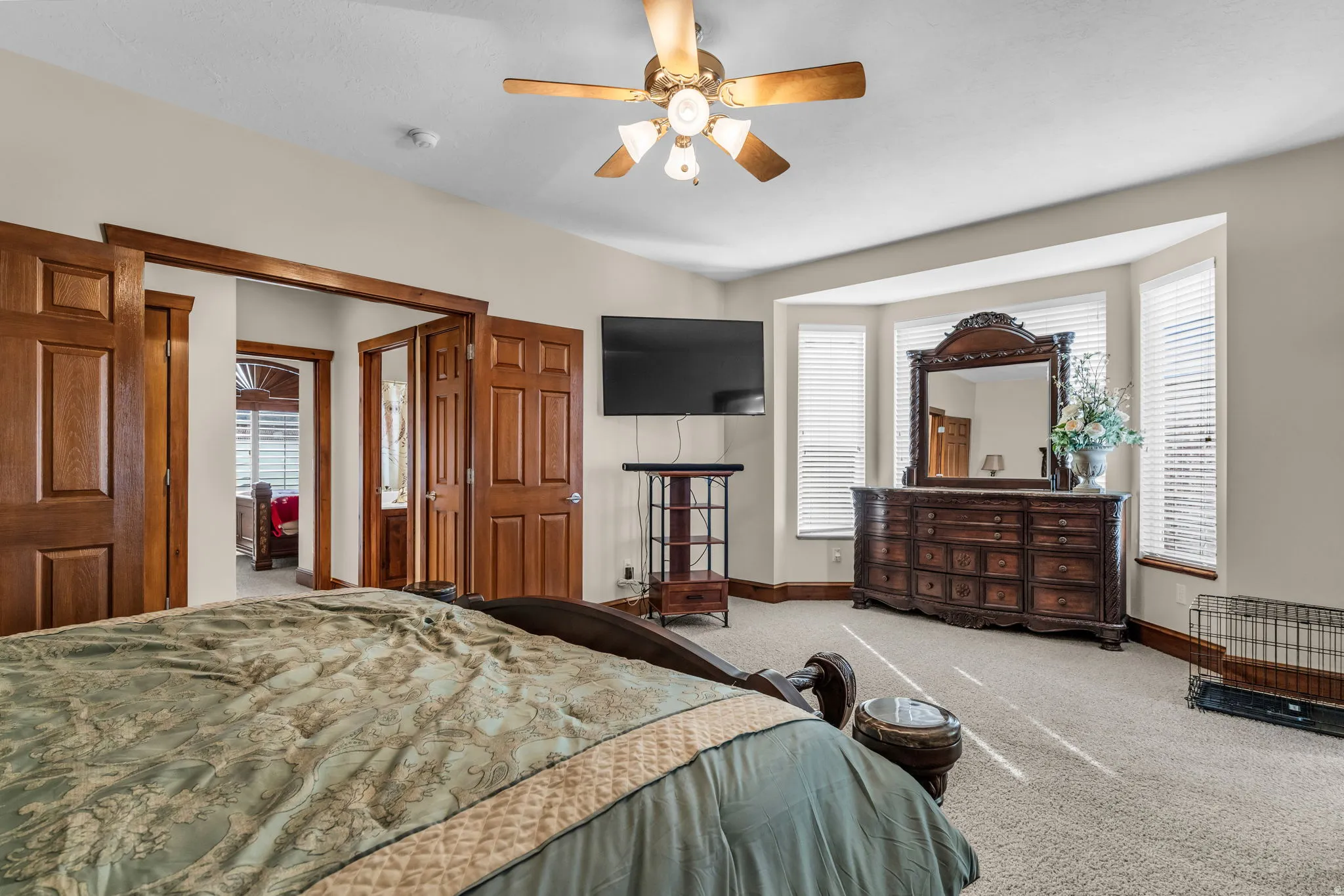 Carpeted bedroom featuring baseboards and a ceiling fan