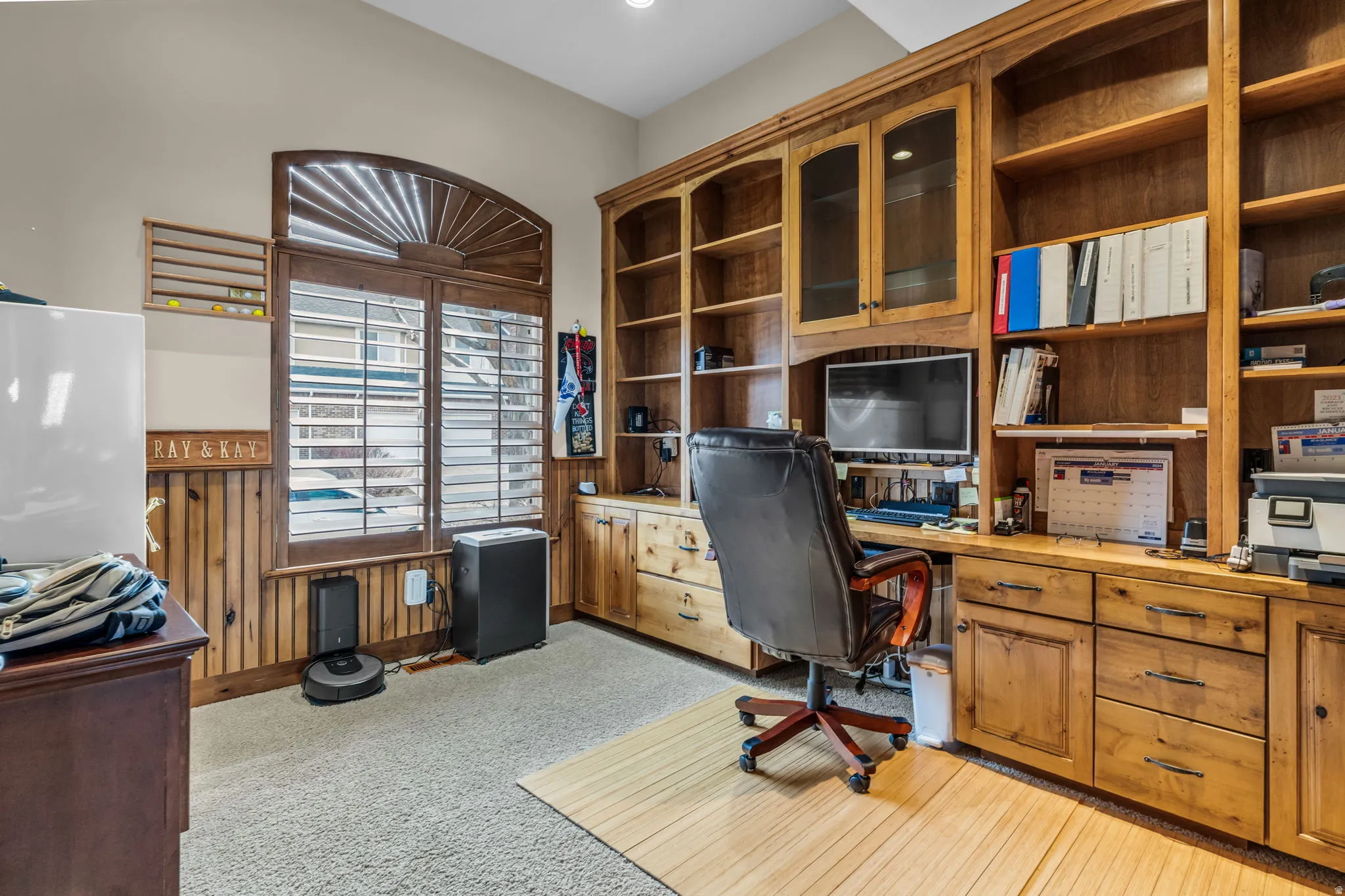 Office with built in study area and light colored carpet
