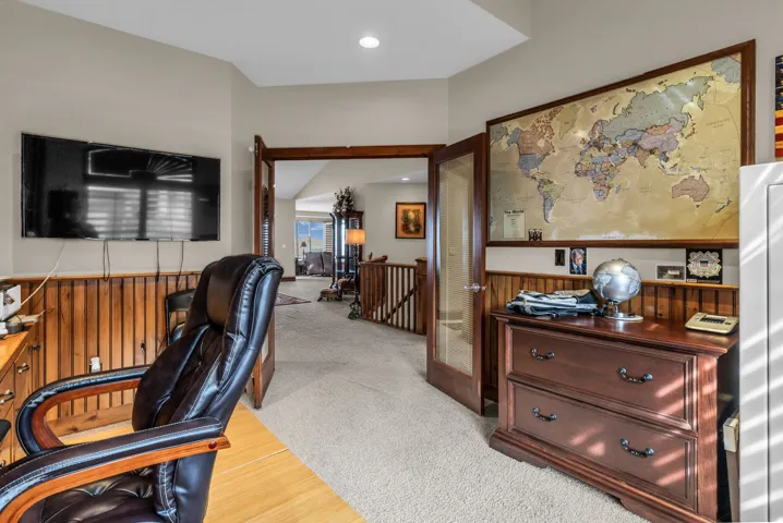 Office space featuring light carpet, lofted ceiling, and recessed lighting