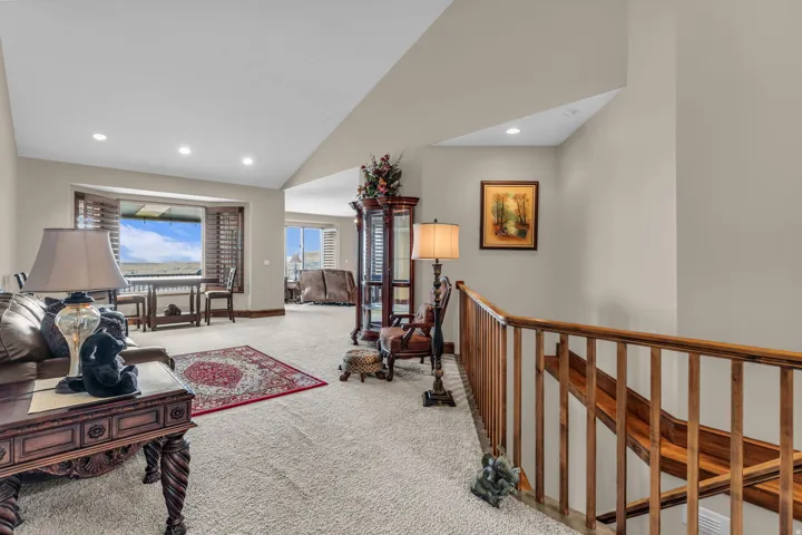 Living room with carpet, vaulted ceiling, and recessed lighting