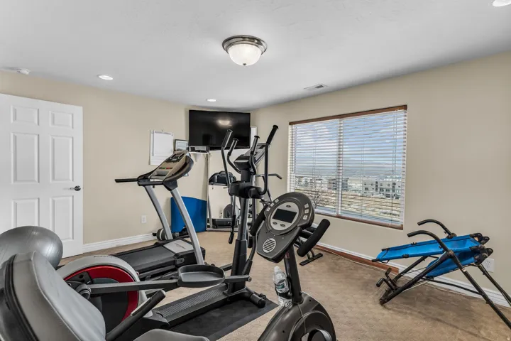 Exercise room featuring recessed lighting