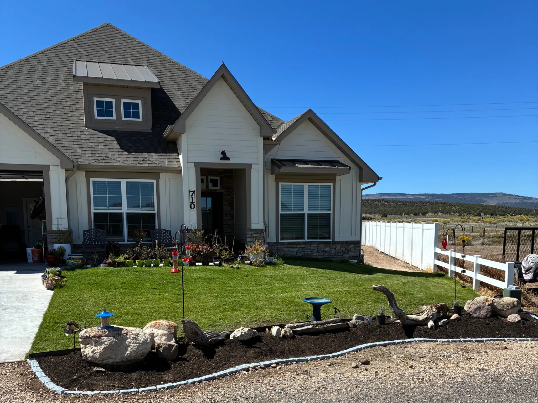 Craftsman-style house with board and batten siding, concrete driveway, and an attached garage