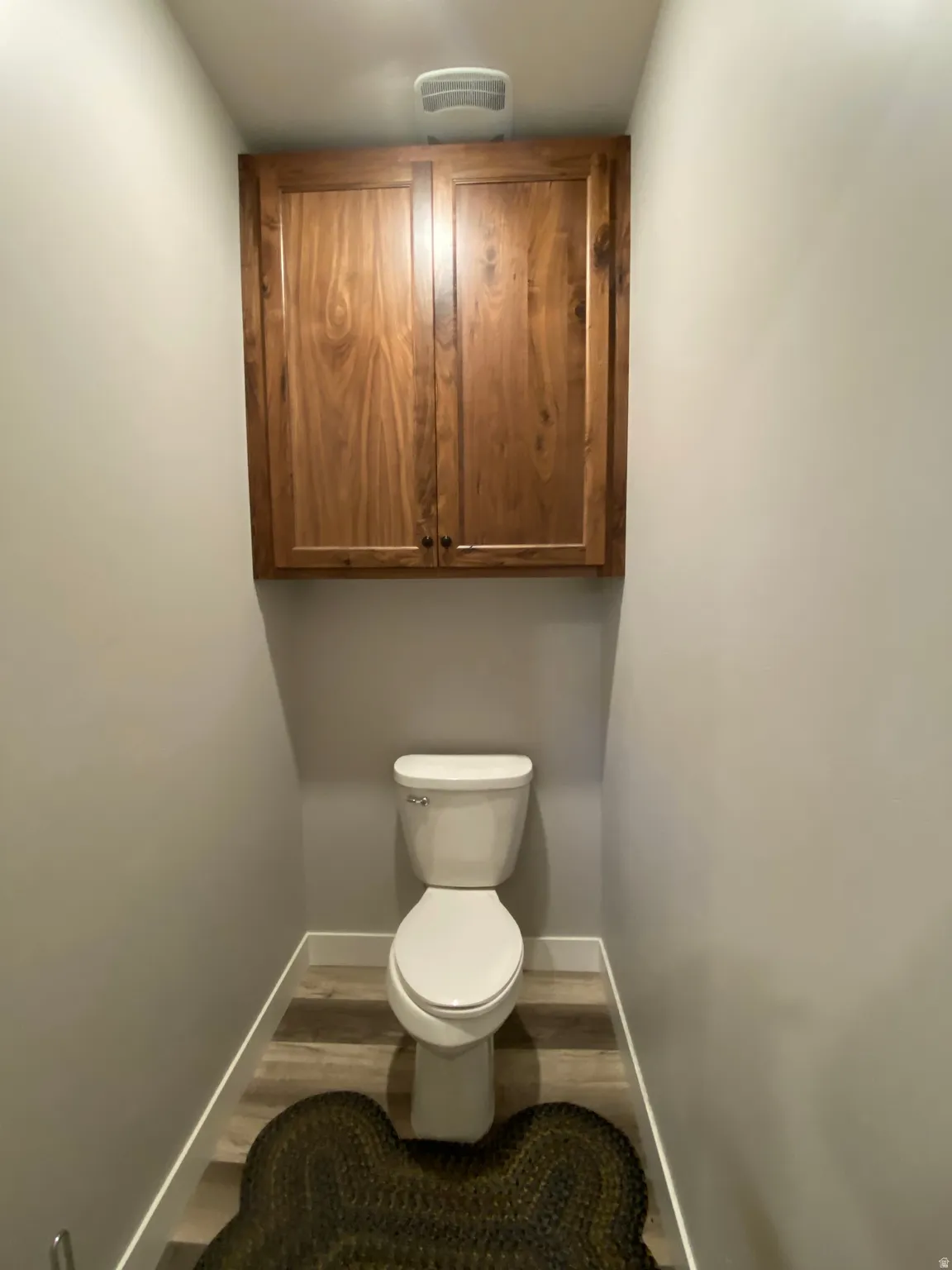 Bathroom with toilet and wood finished floors