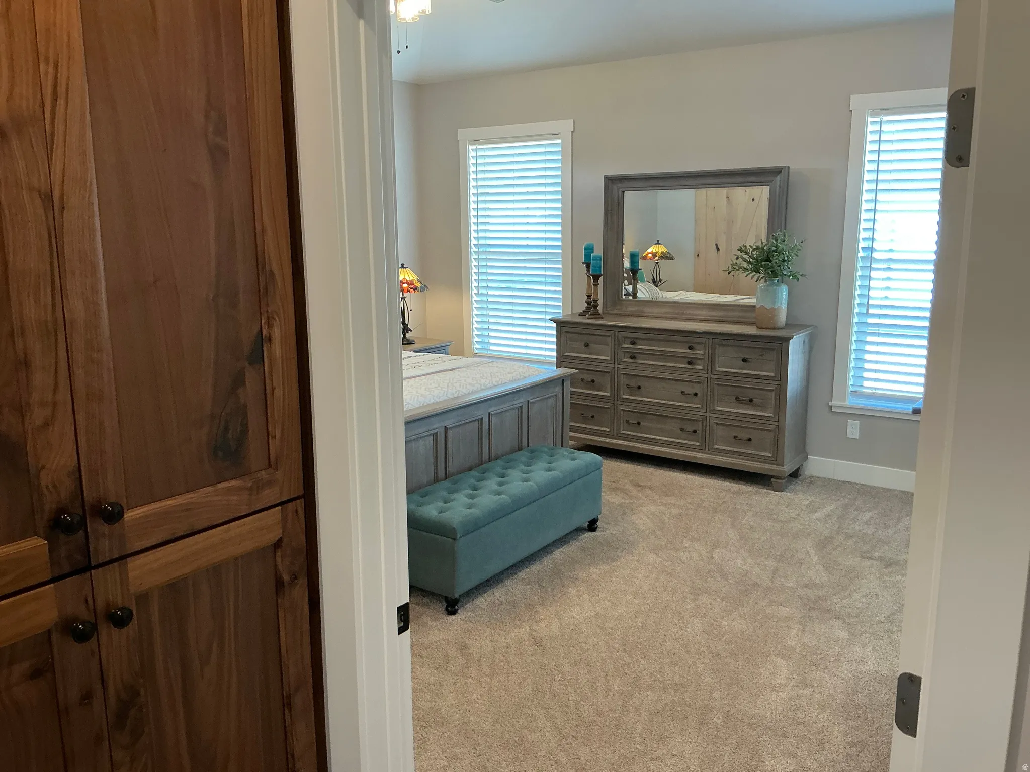 Bedroom featuring light colored carpet and baseboards