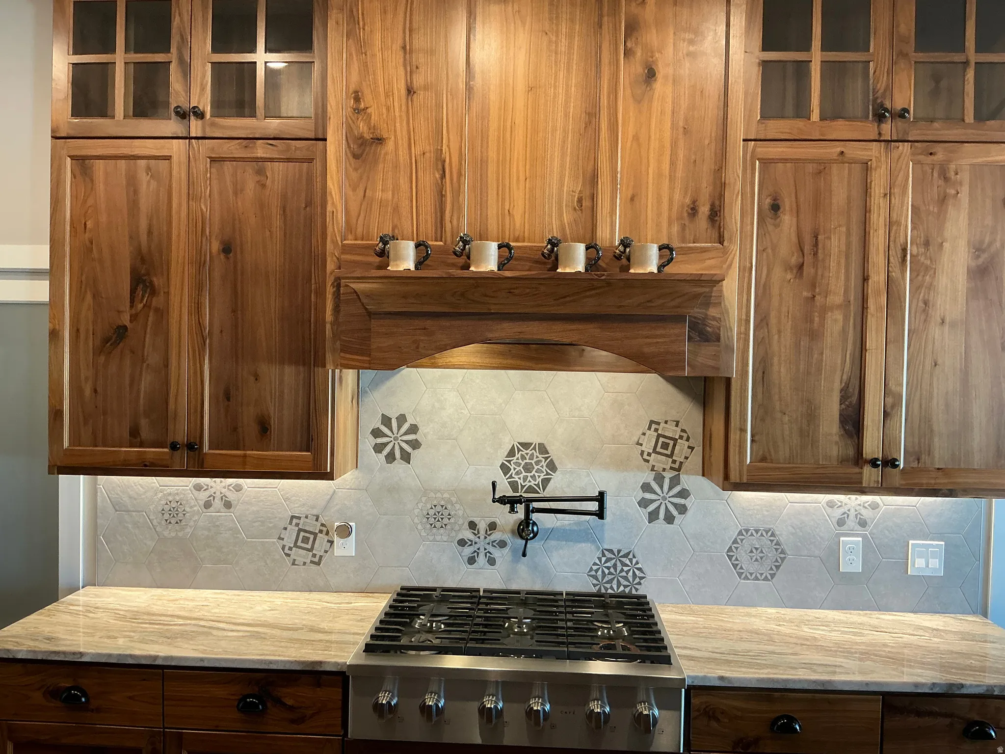 Kitchen featuring glass fronted cabinets and wood finish cabinetry