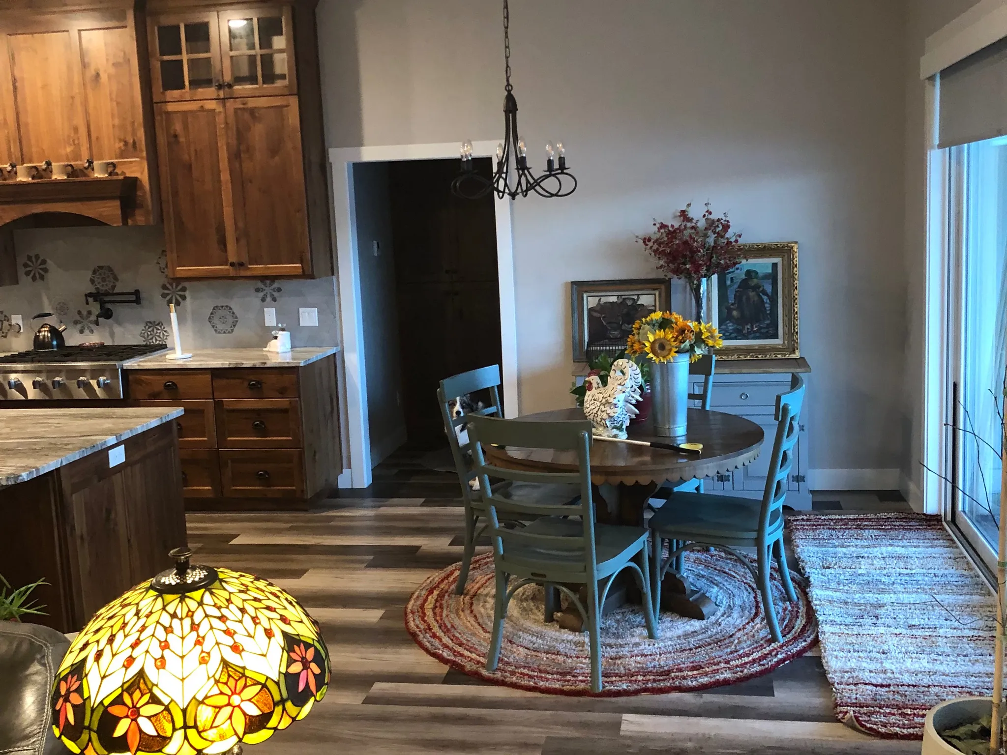 Dining room featuring dark wood-type flooring and hanging lights