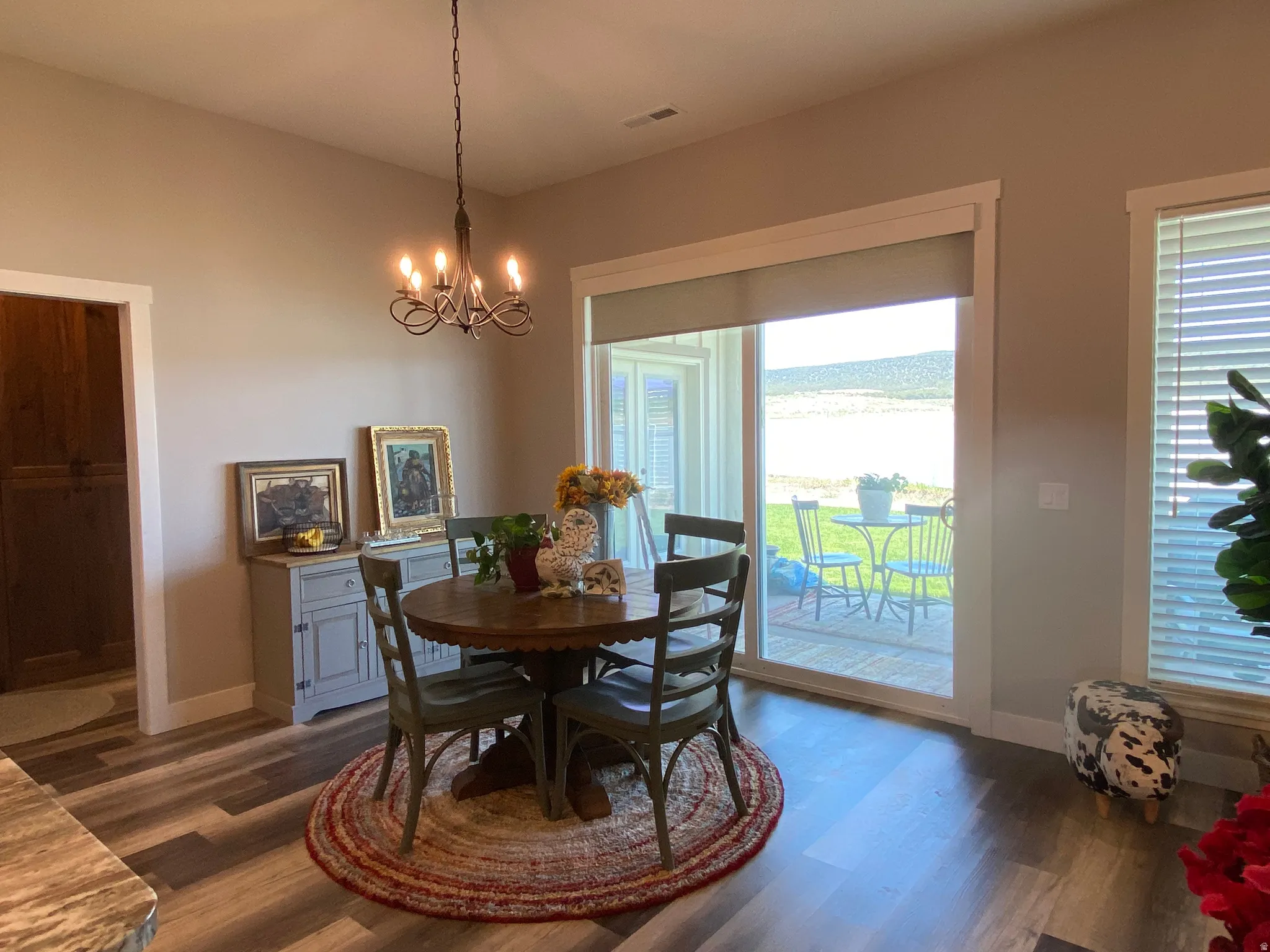 Dining area featuring dark wood-style floors and a chandelier
