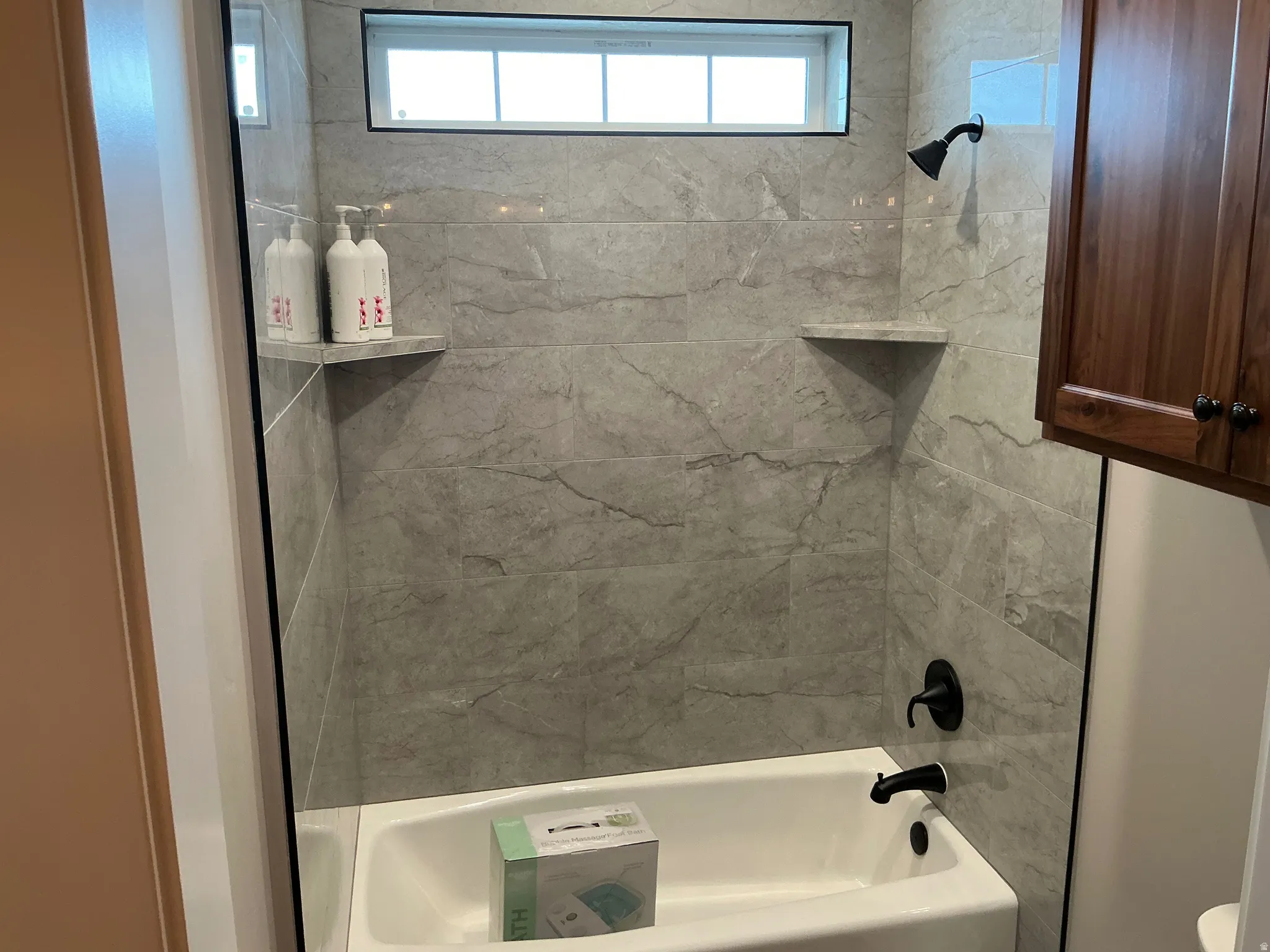 Full bathroom with  shower combination and healthy amount of natural light