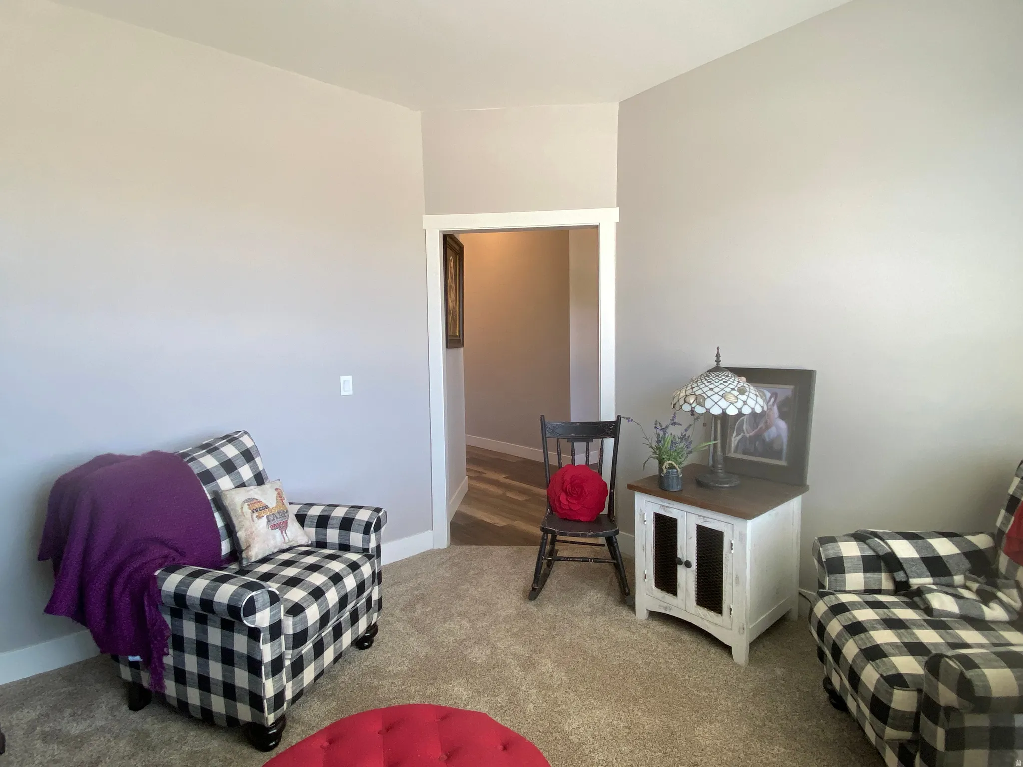 Sitting room featuring carpet and baseboards