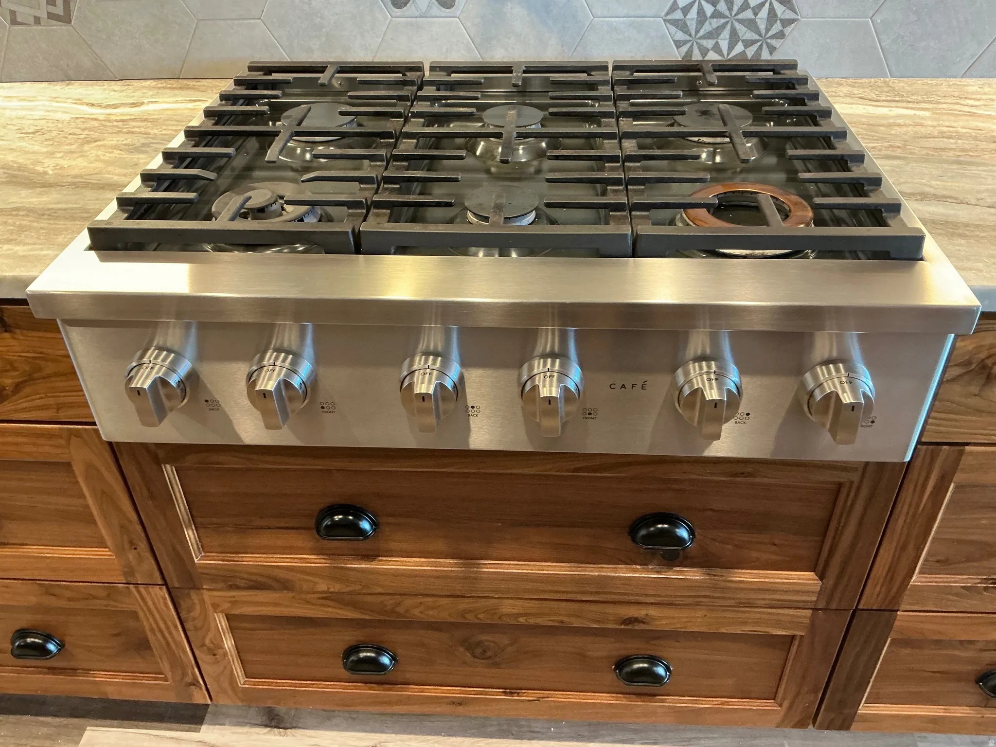 Kitchen view of tasteful backsplash and wood finish cabinetry