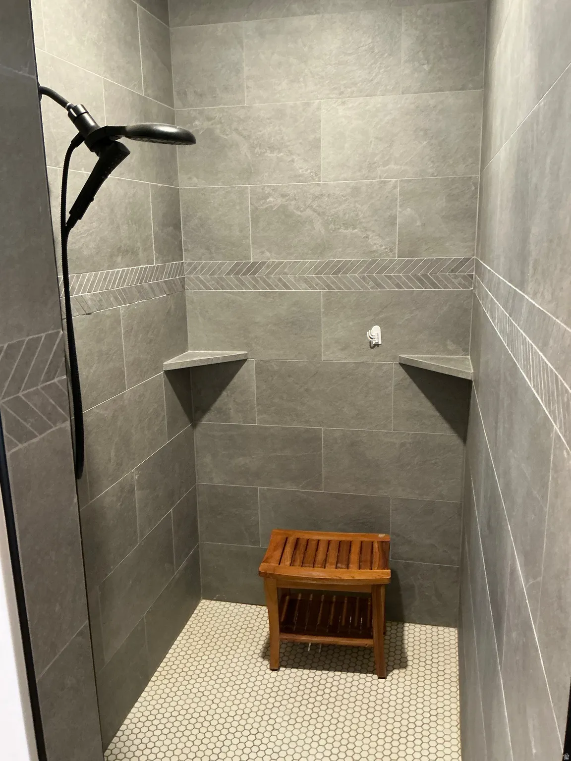 Full bath featuring tiled shower