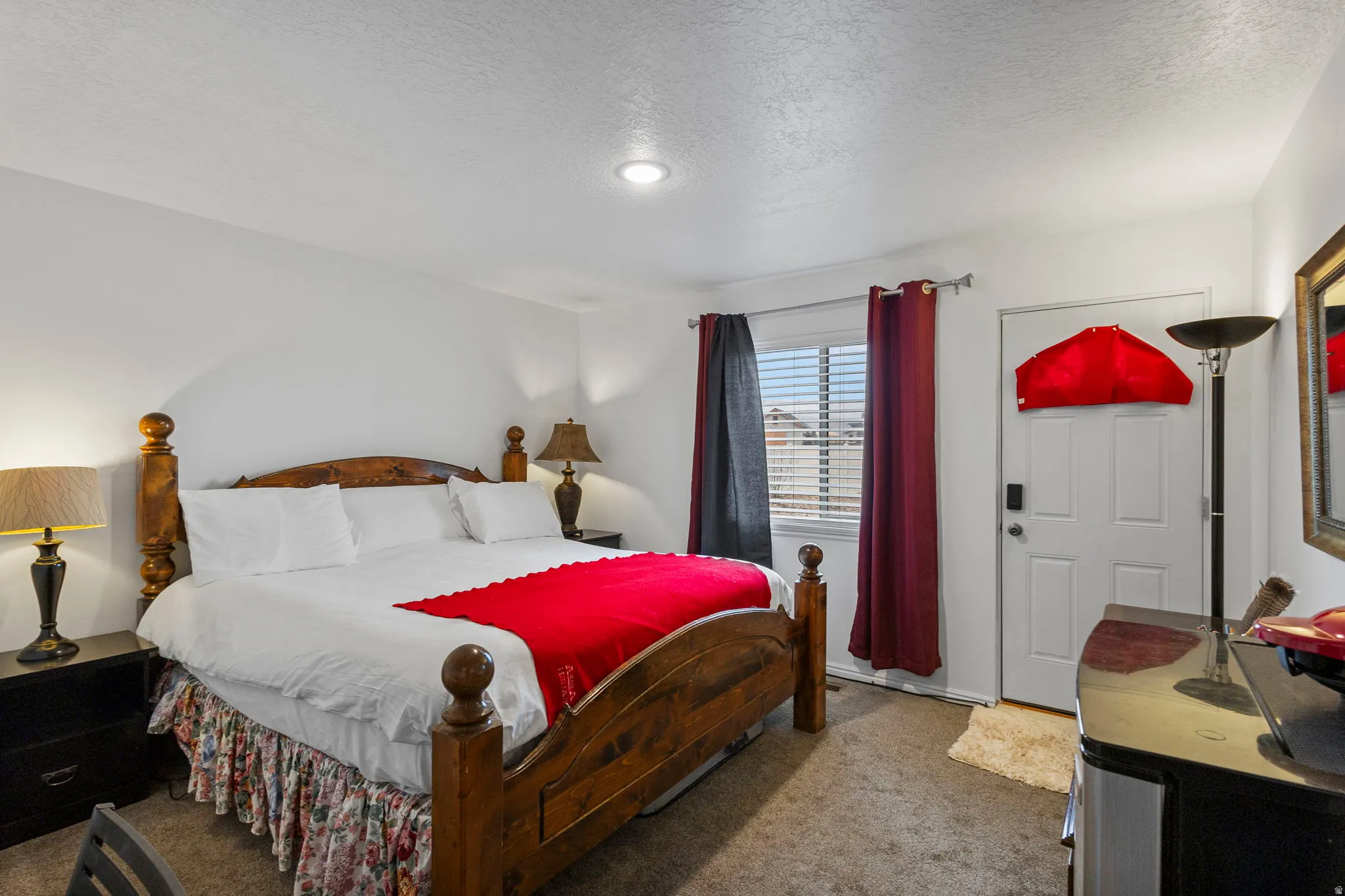Carpeted bedroom with a textured ceiling