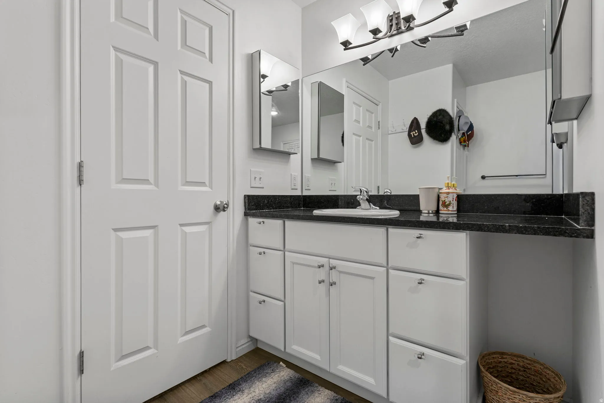 Bathroom with vanity and dark wood-type flooring