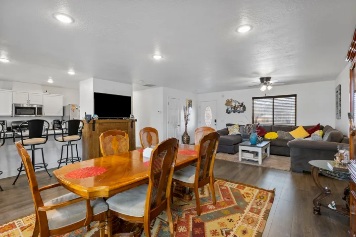Dining space with wood-type flooring, ceiling fan, and a textured ceiling