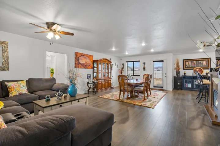 Living area with wood-type flooring and a ceiling fan
