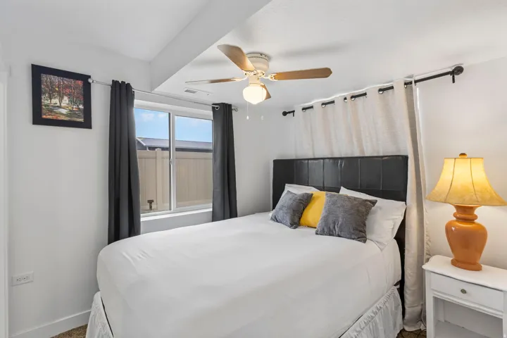 Bedroom with ceiling fan and carpet floors