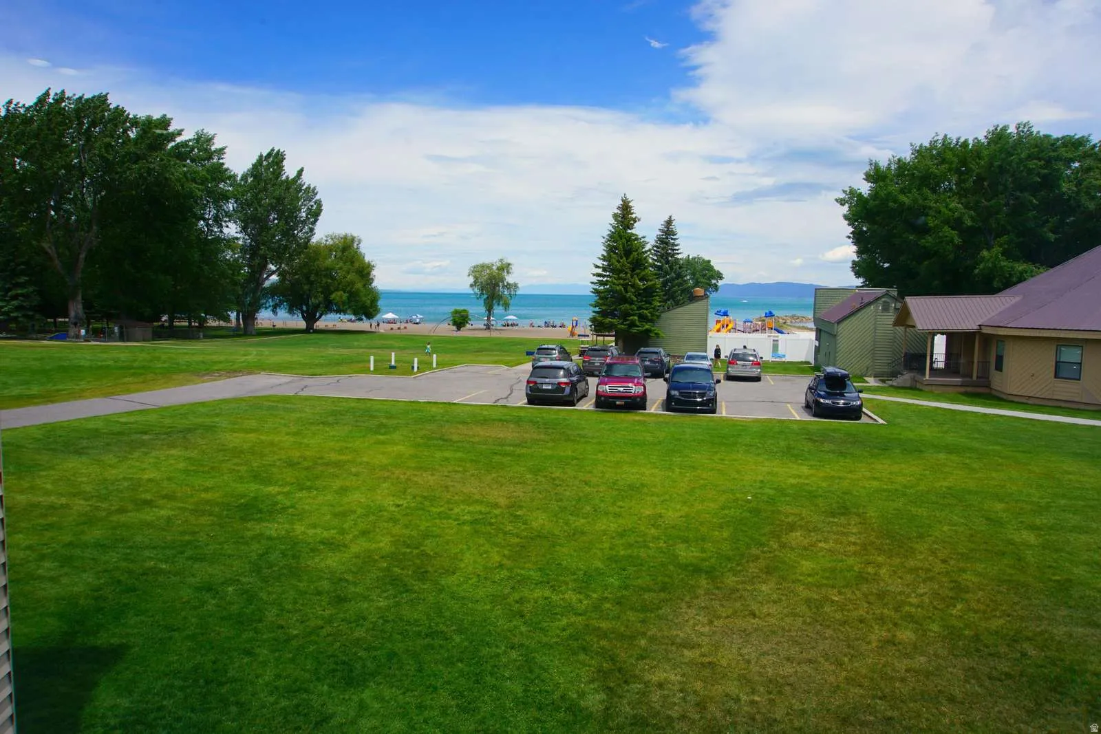 View of green lawn featuring a water view