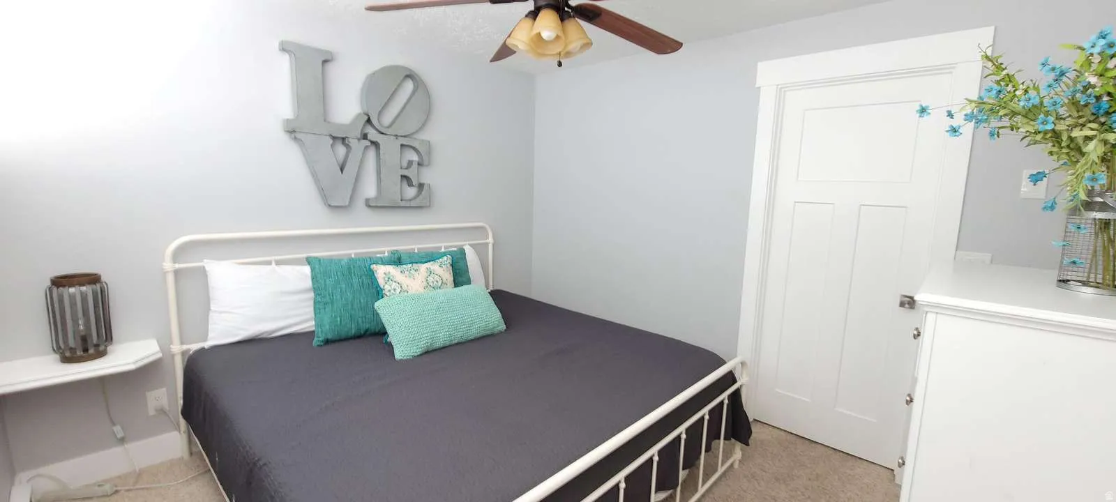 Bedroom featuring ceiling fan and light colored carpet