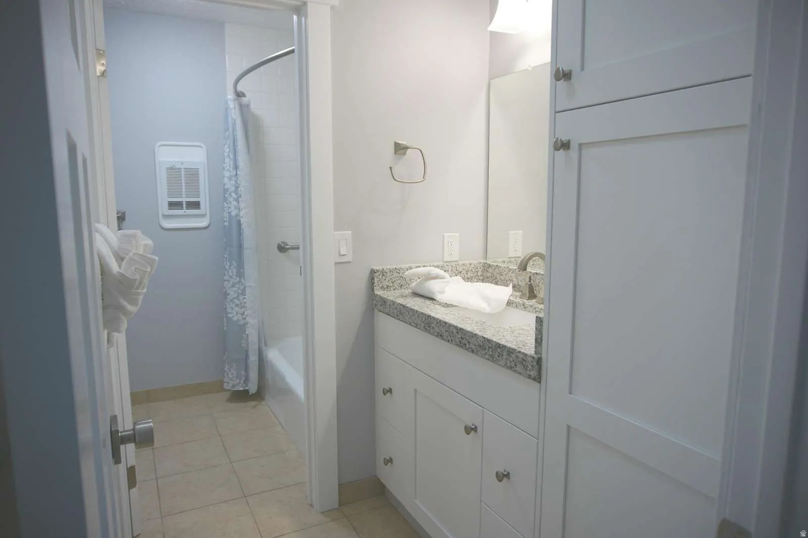 Full bath with vanity, shower / bath combination with curtain, and light tile patterned flooring