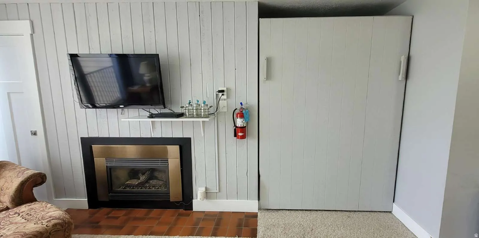 Detailed view of a fireplace with flush hearth and wood walls