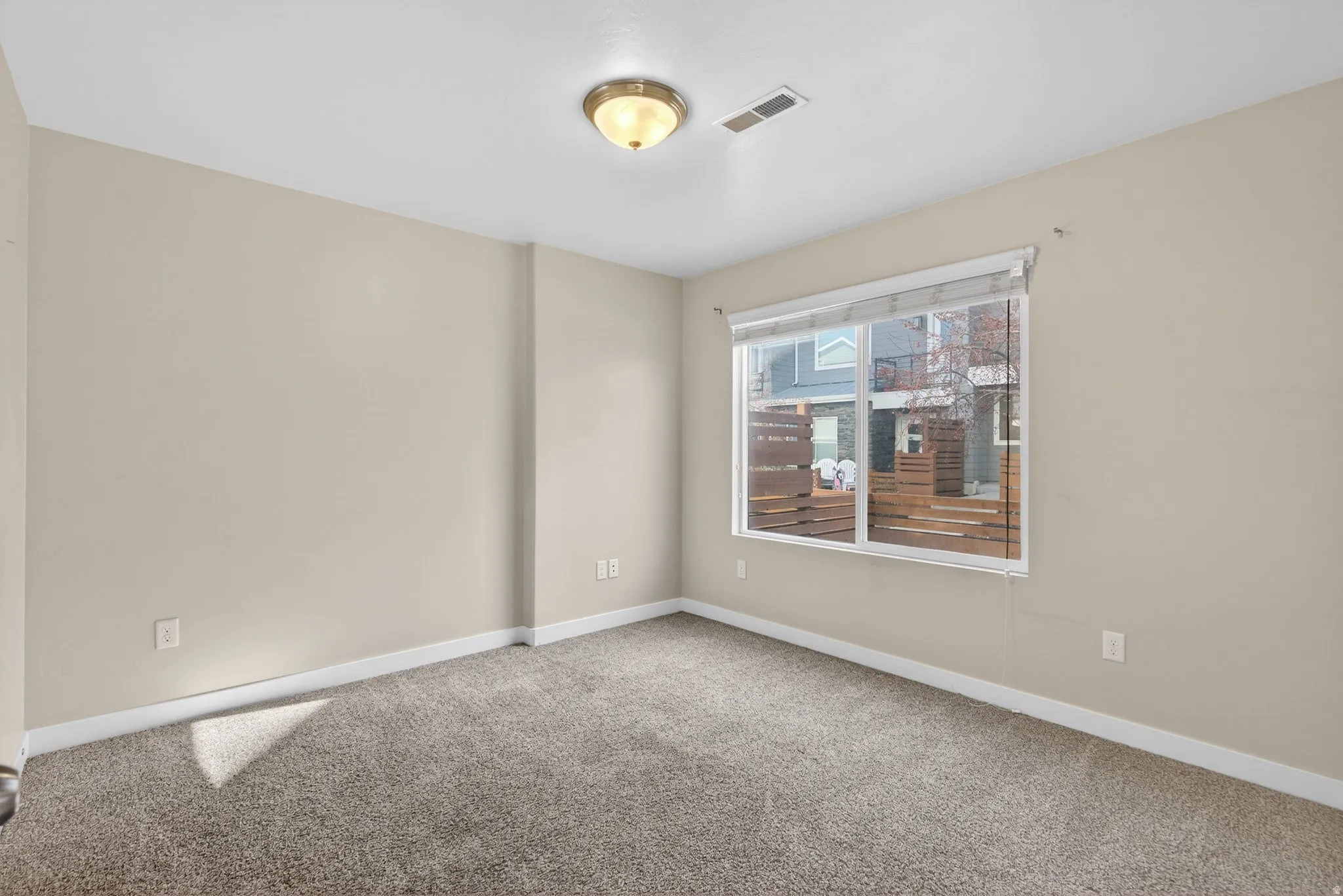 Carpeted empty room with baseboards