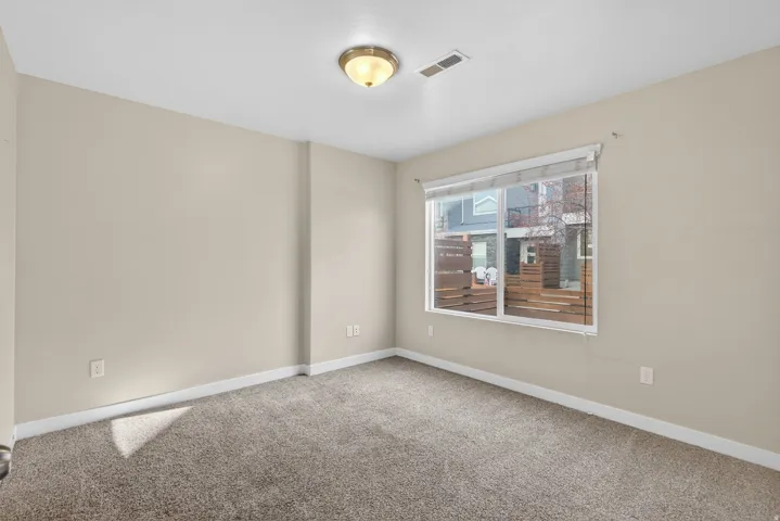 Carpeted empty room with baseboards