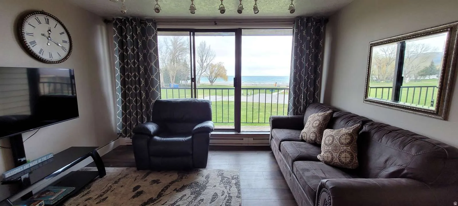 Living room featuring a water view and wood-type flooring