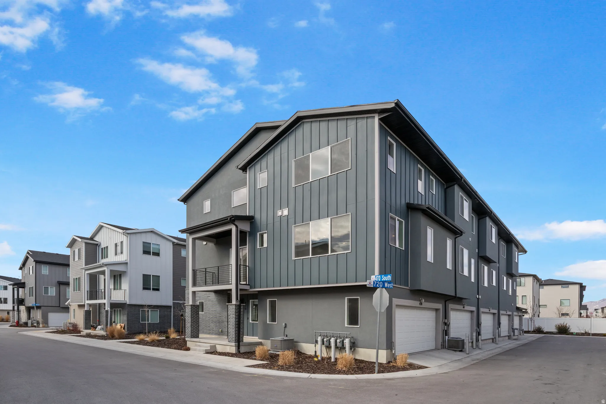 View of property with a residential view and a garage