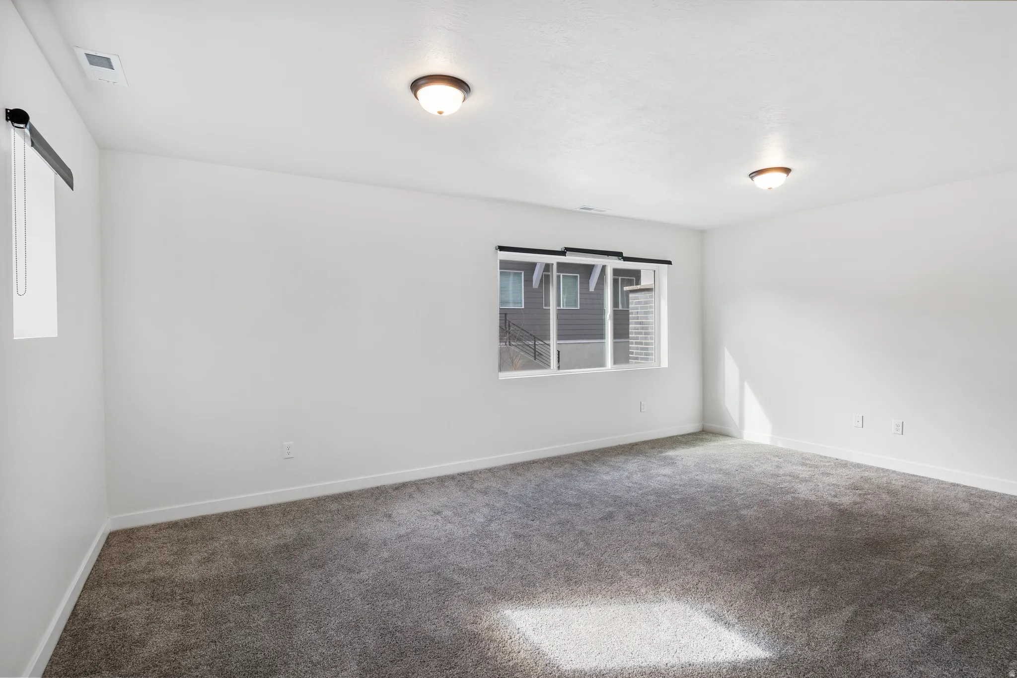 Carpeted empty room with baseboards