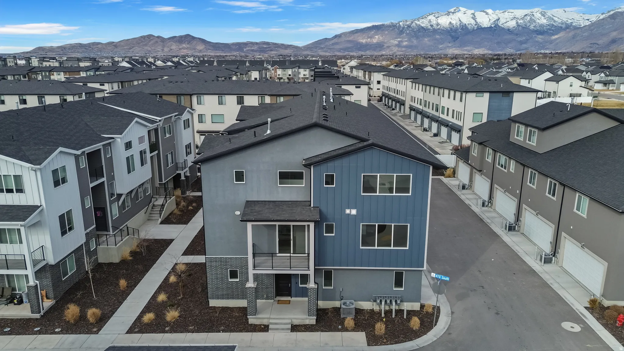 Aerial perspective of suburban area featuring a mountain backdrop