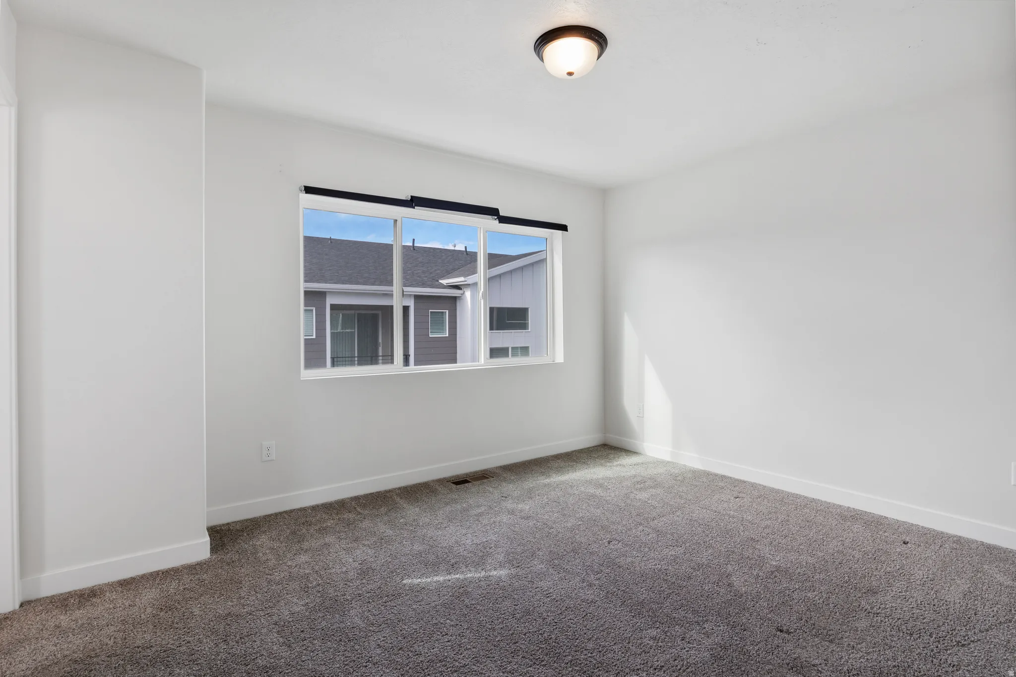 Spare room featuring baseboards and carpet floors