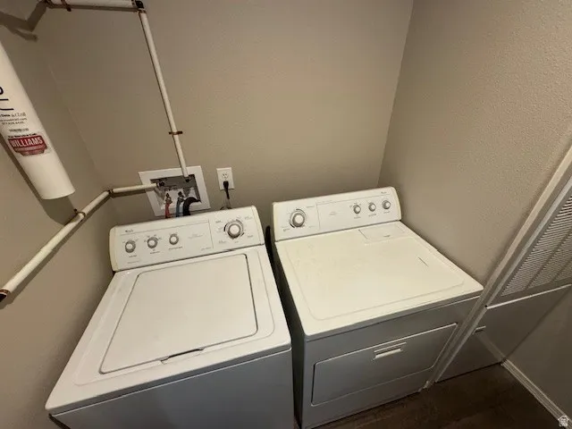 Laundry area with independent washer and dryer and a textured wall