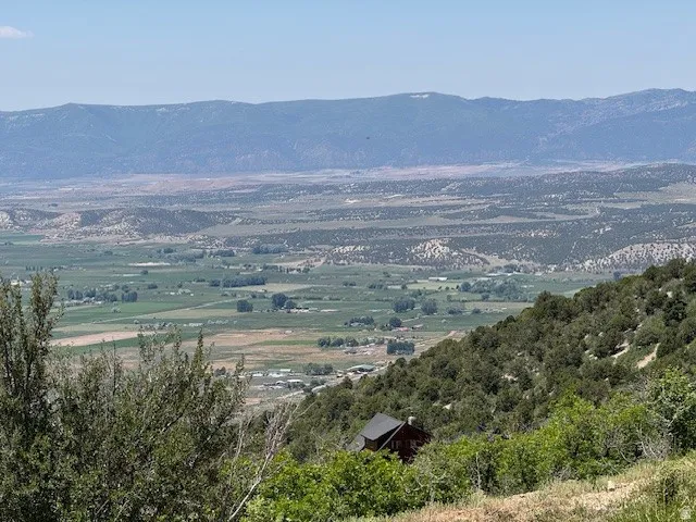 View of mountain backdrop with rural landscape