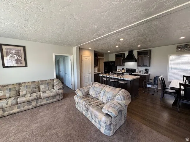 Living area featuring recessed lighting and a textured ceiling