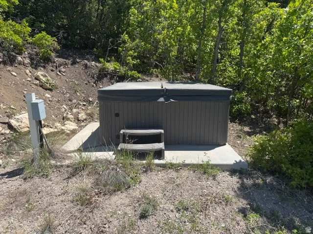 View of outbuilding with a hot tub
