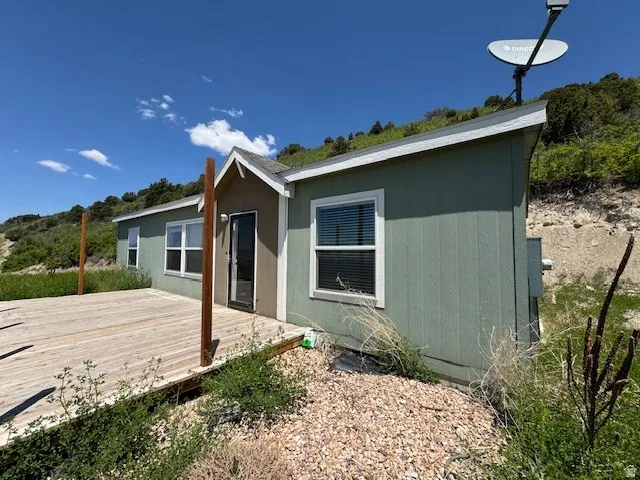 Back of house with a deck