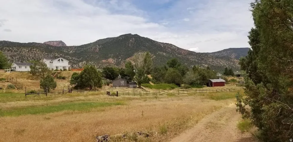 View of mountain backdrop with rural landscape