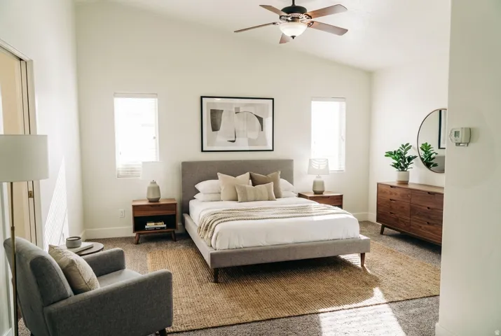 Bedroom with lofted ceiling, carpet flooring, and a ceiling fan