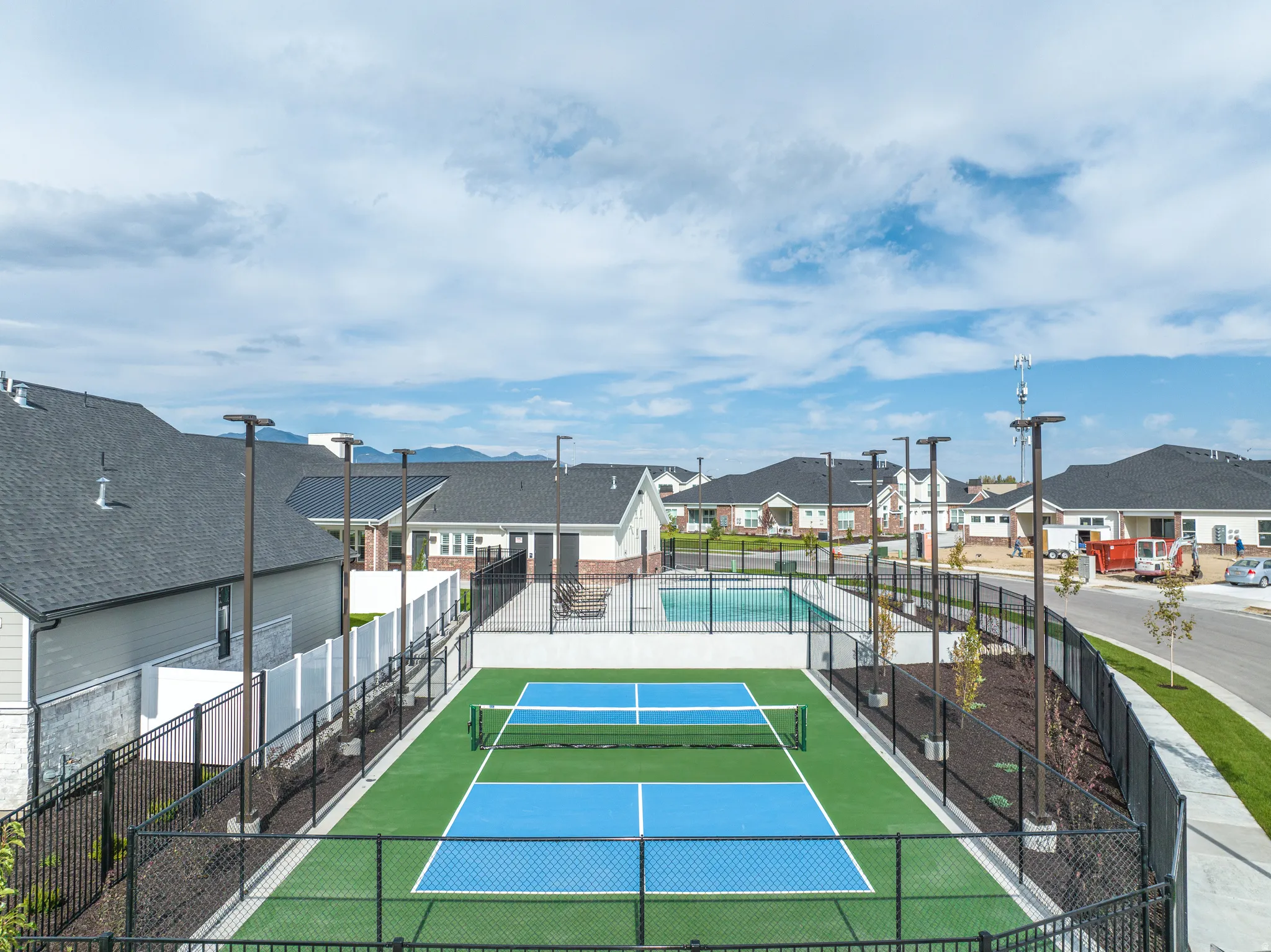 View of tennis court featuring a residential view