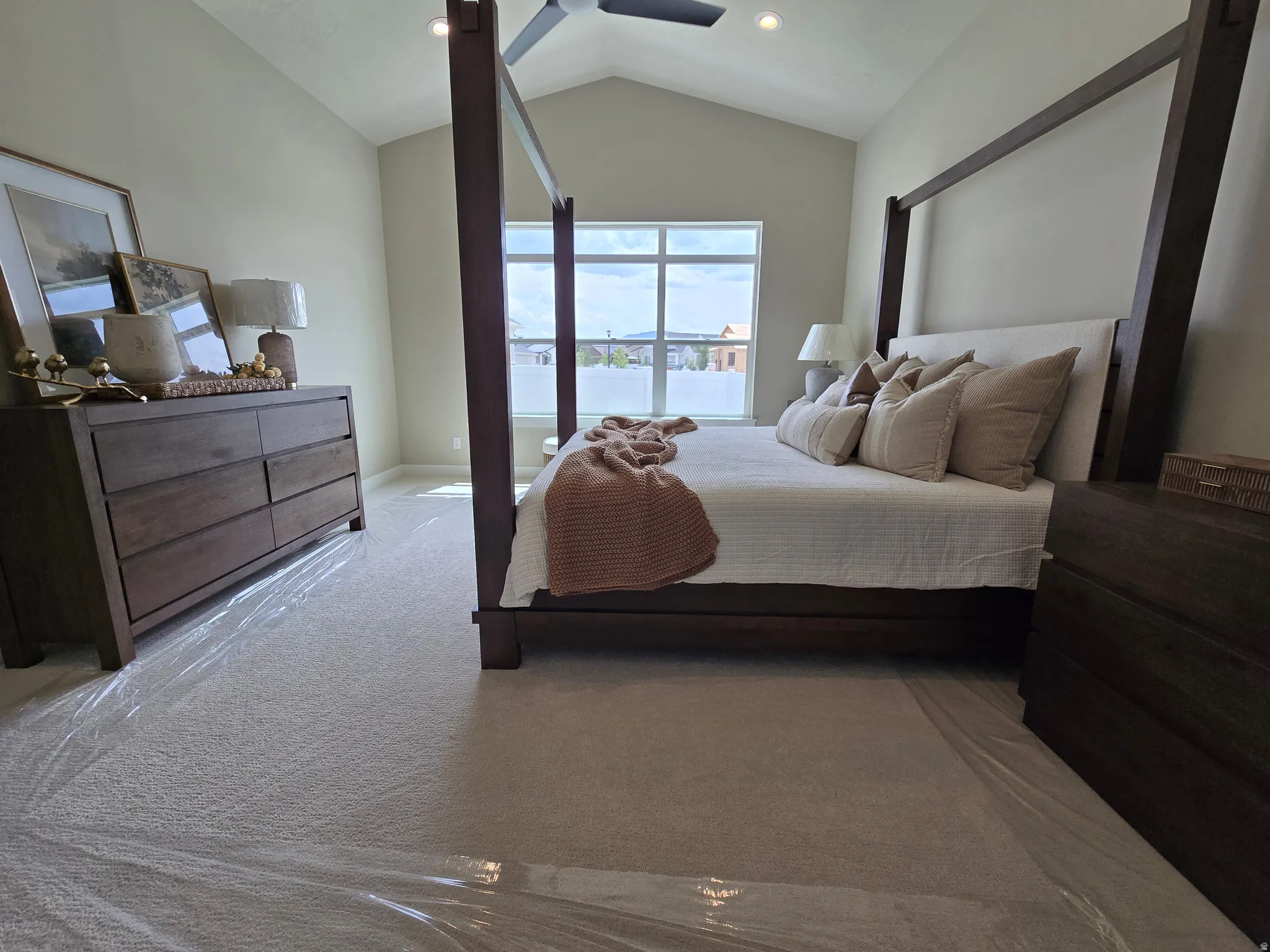 Carpeted bedroom with a ceiling fan and baseboards
