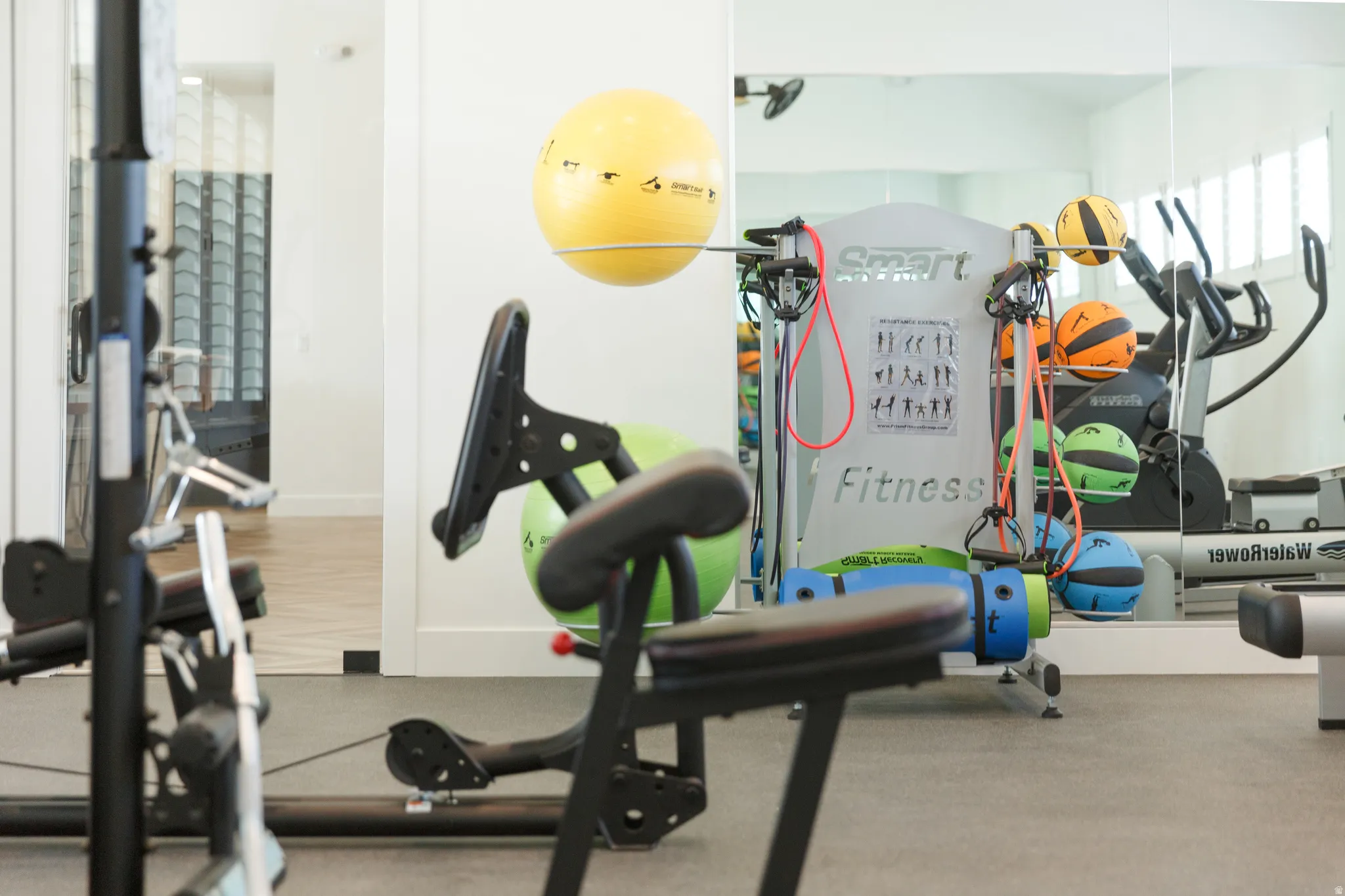 Exercise room with baseboards and rubber floors