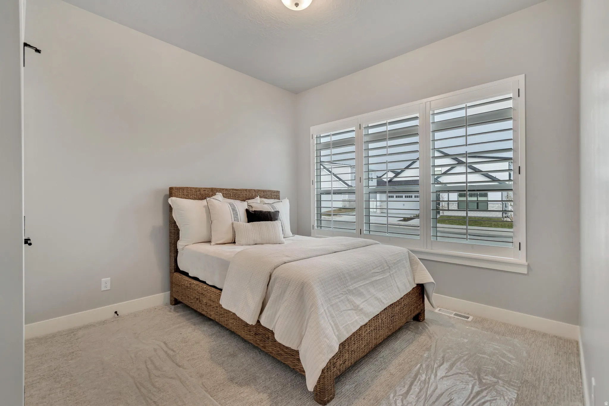Carpeted bedroom featuring baseboards