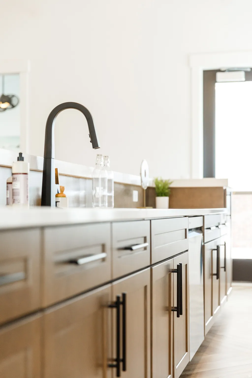 Kitchen view of light countertops and light wood-type flooring