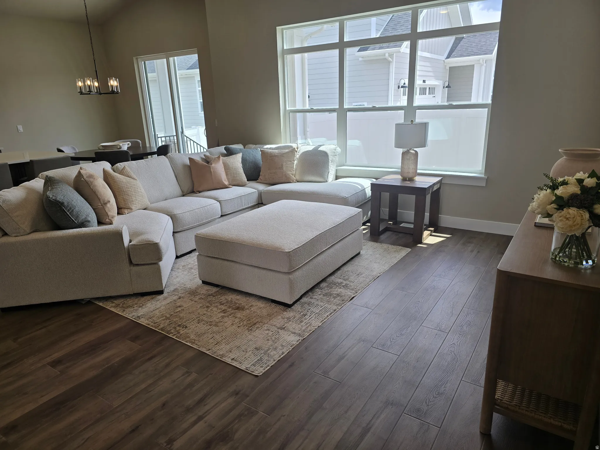 Living room featuring hardwood / wood-style floors and suspended lighting