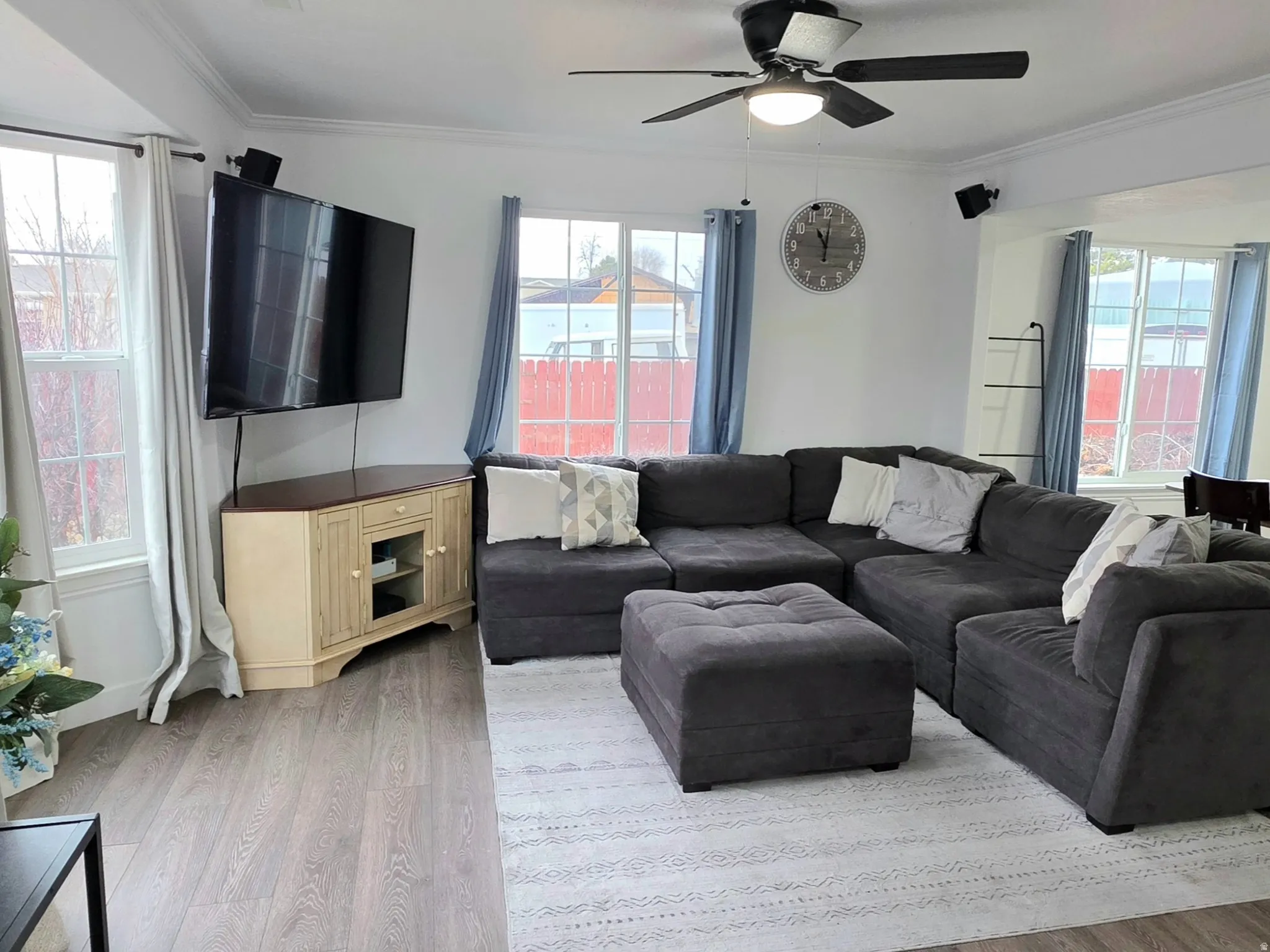 Living area featuring ceiling fan, wood finished floors, and healthy amount of natural light