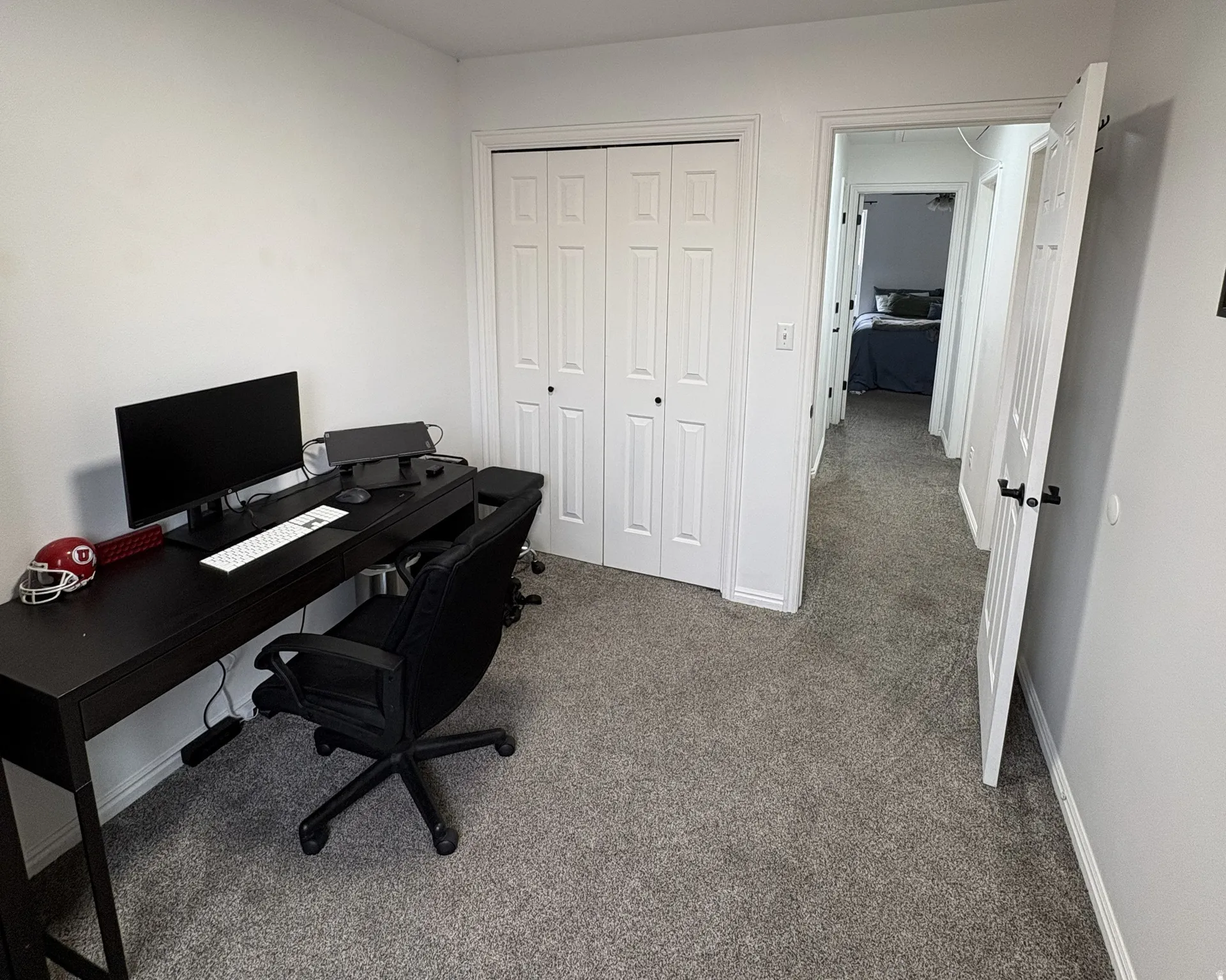 Office featuring light colored carpet and baseboards