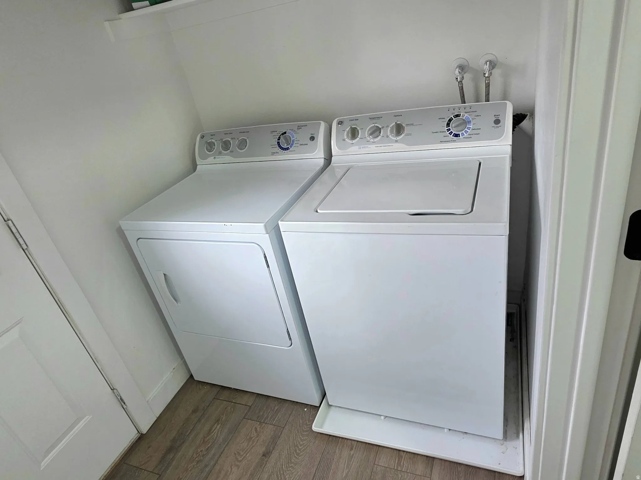 Laundry room featuring washer and dryer hook-ups and wood finished floors