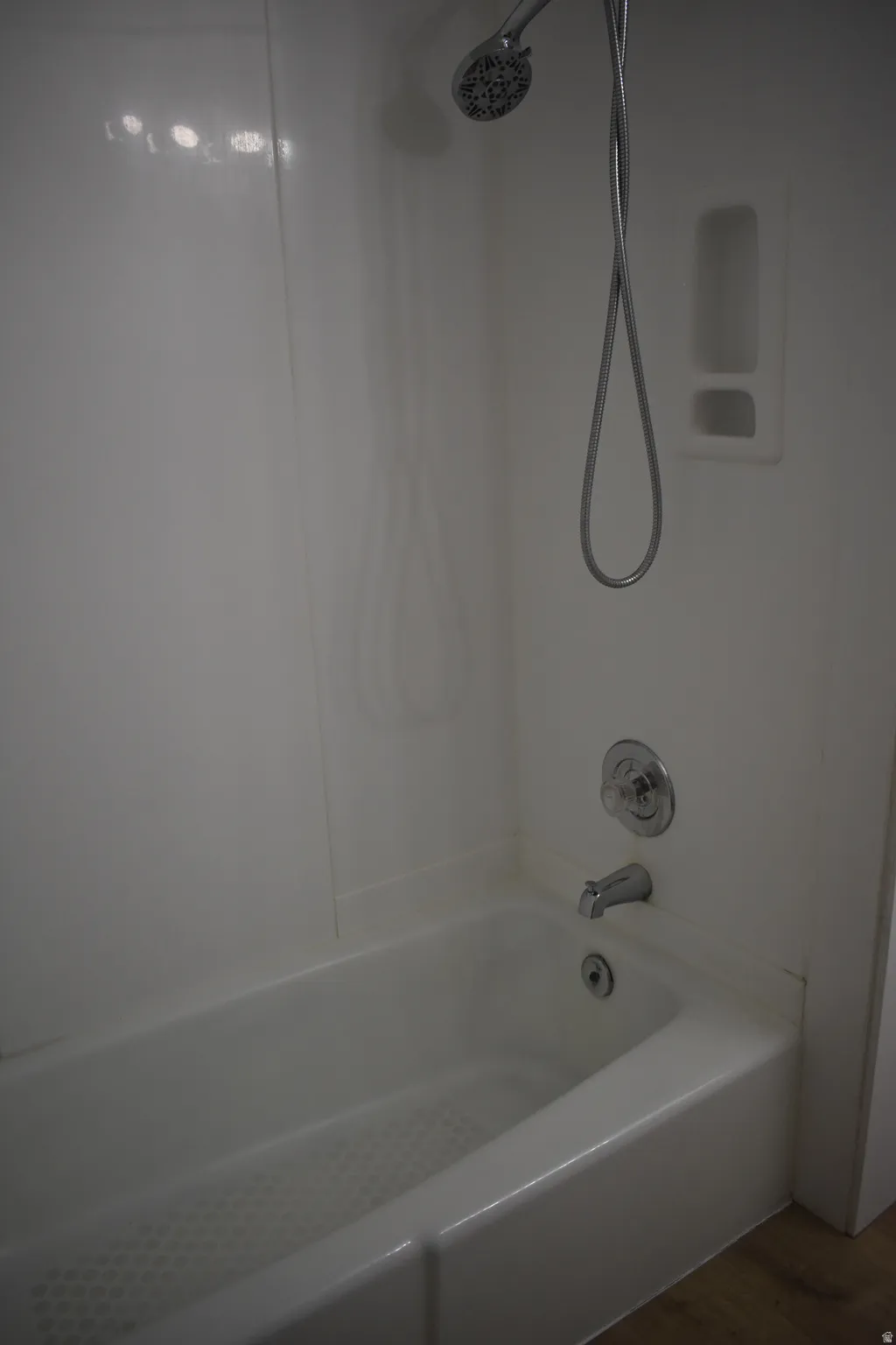 Bathroom with  shower combination and dark wood finished floors