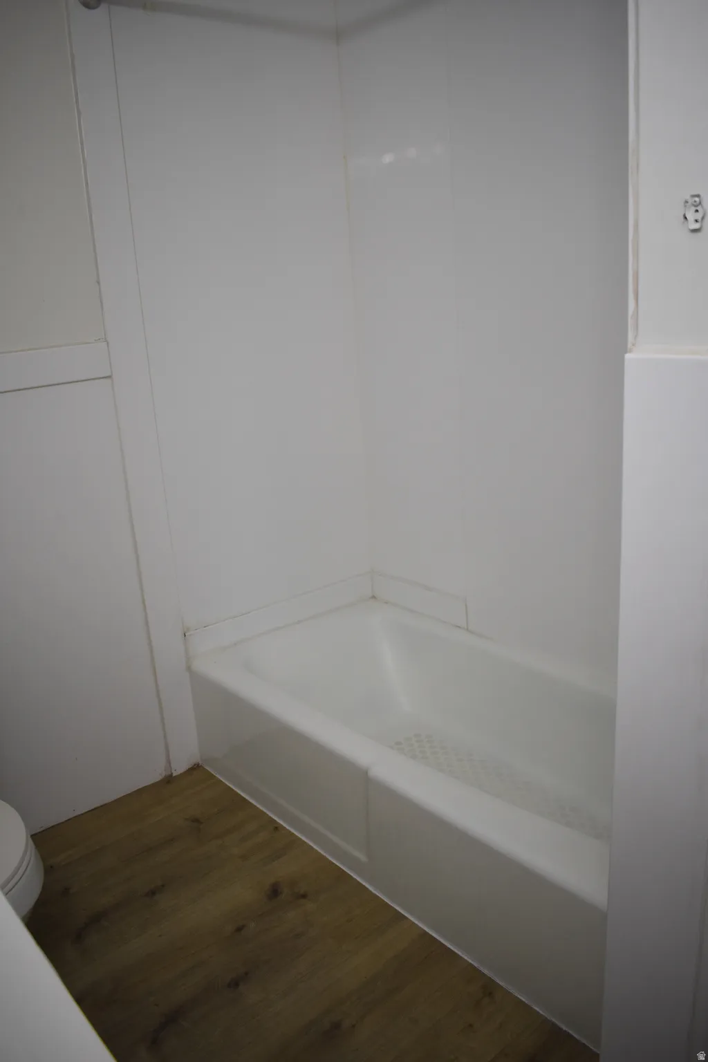 Full bath featuring dark wood finished floors