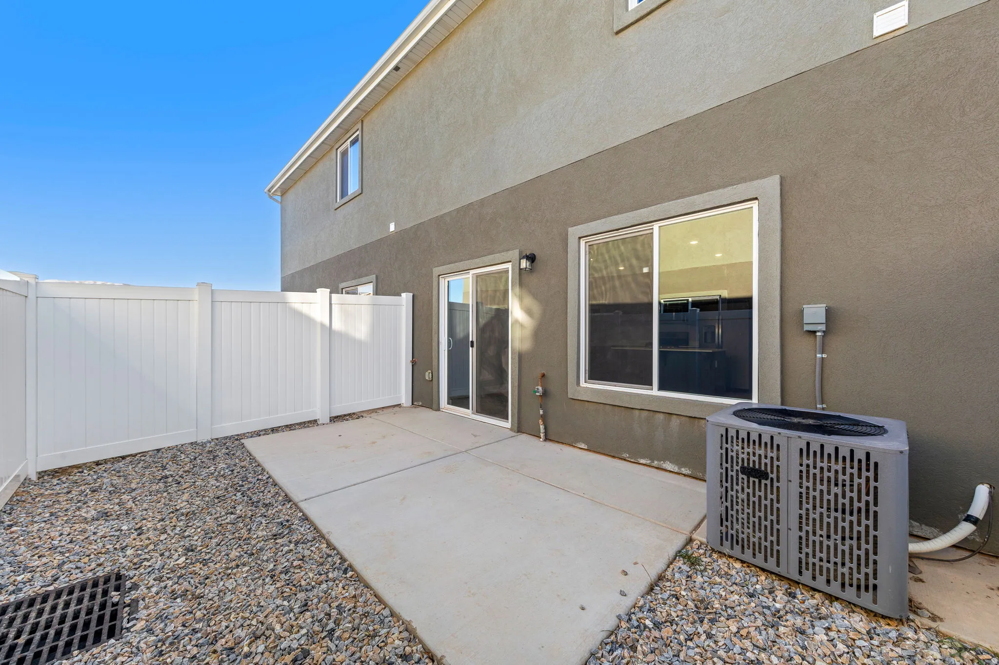 Rear view of house featuring a patio and stucco siding